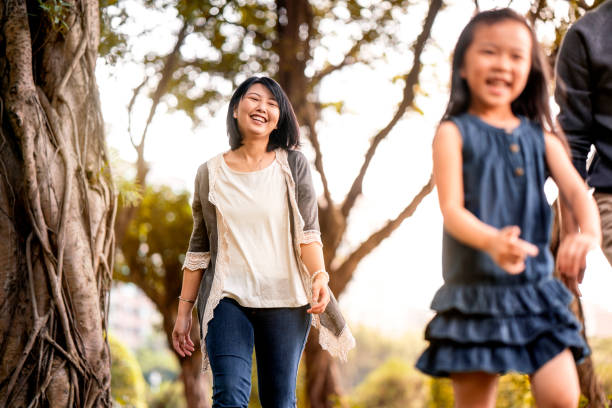 istock Cheerful mother walking with daughter in park 1151925724