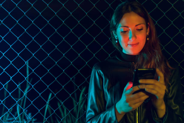 istock Young woman using phone at night 1151927326