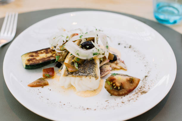 istock Roasted fish with vegetables and fresh herbs 1151930461