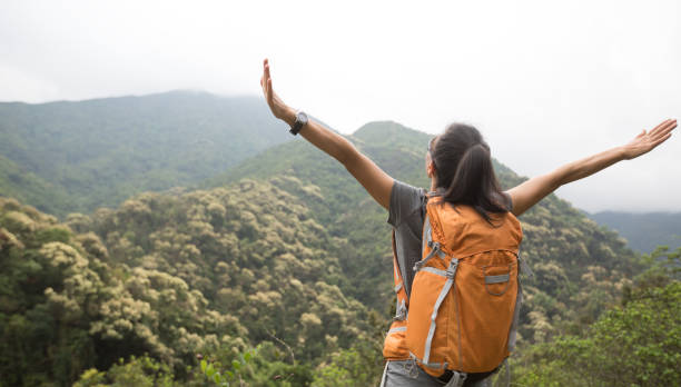 istock young woman backpacker hiking at forest mountain top 1151930542