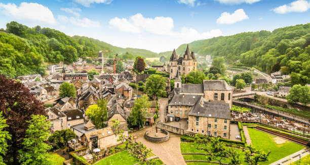 Panoramic landscape of Durbuy, Belgium. Smallest city in the world. Aerial view of city centre of Durbuy. Buildings and green nature. Blue sky with white clouds. Panoramic view. Bright and colorful image. belgium stock pictures, royalty-free photos & images