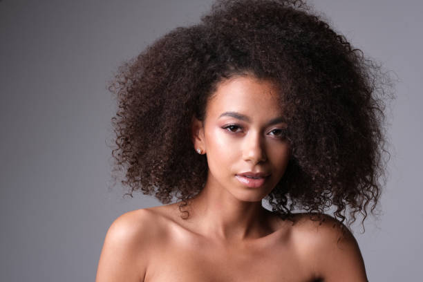 istock Beautiful young black woman on grey background. 1151932961