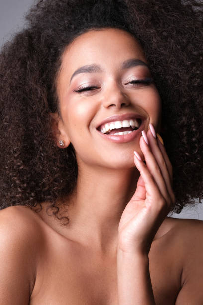 istock Pretty young black woman on grey background. 1151933023