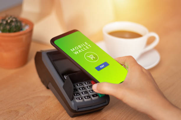 istock cashless Society, customer paying bill through smartphone using NFC technology in cafe. mobile digital wallet technology concept 1151933939