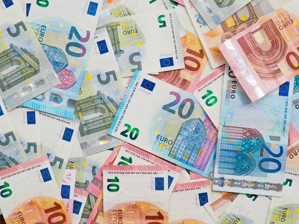 istock many dollar and euro banknote as background. 1151934824