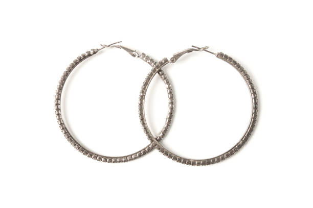 Female metal earrings in the form of rings isolated on white background