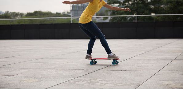 woman skateboarder skateboarding at city