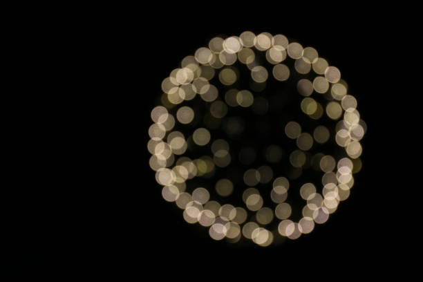 istock Bokeh circle Light yellow gold sphere on a black background 1151938628