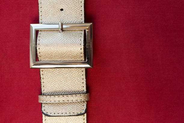 istock Strapped? Leather belts in gold, close-up 1151941453