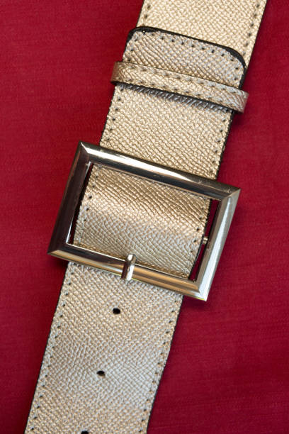 istock Strapped? Leather belts in gold, close-up 1151941511