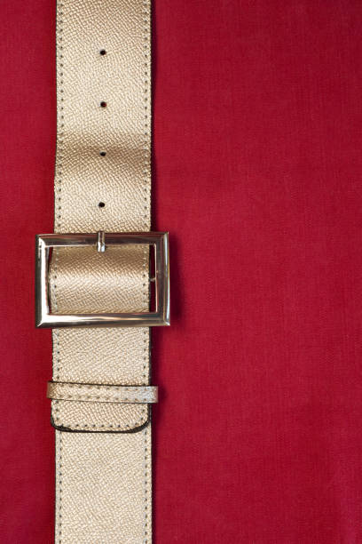 istock Strapped? Leather belts in gold, close-up 1151941572