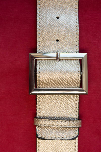 istock Strapped? Leather belts in gold, close-up 1151941613
