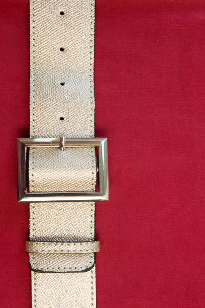 istock Strapped? Leather belts in gold, close-up 1151941658