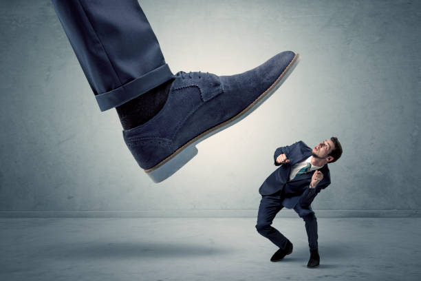 istock Employee getting trampled by big shoe 1151943801