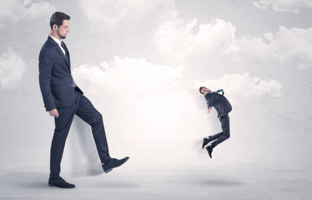 istock Big boss kicking little employee 1151945388