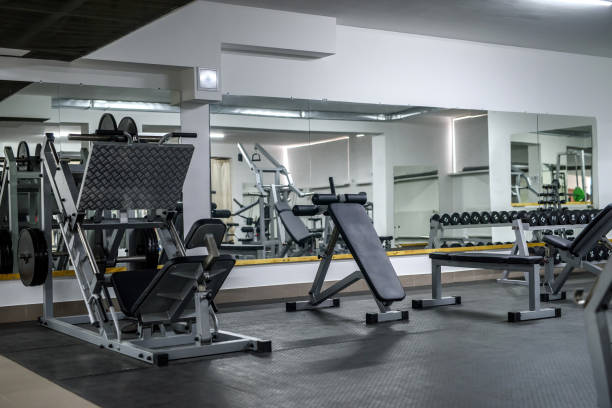 istock Modern interior of light gym with different equipment 1151947478