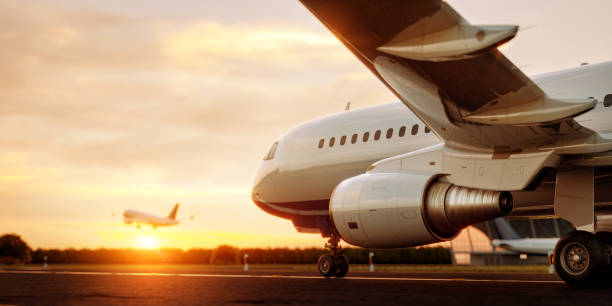 White commercial airplane standing on the airport runway at sunset. Passenger airplane is taking off. Airplane concept 3D illustration. stock photo