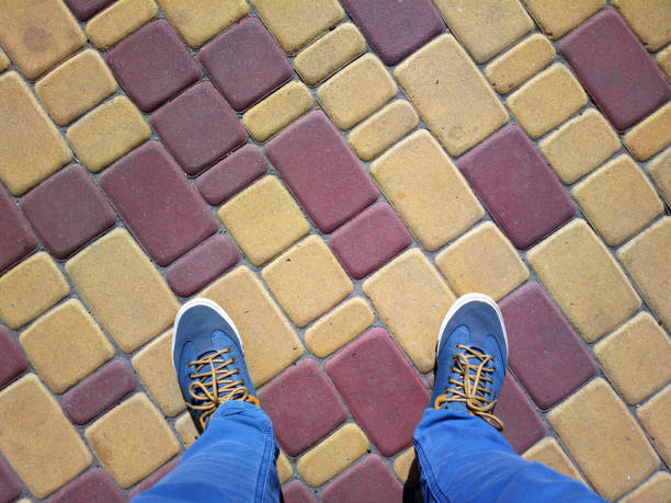 istock Feet on the colored pavement. 1151953304