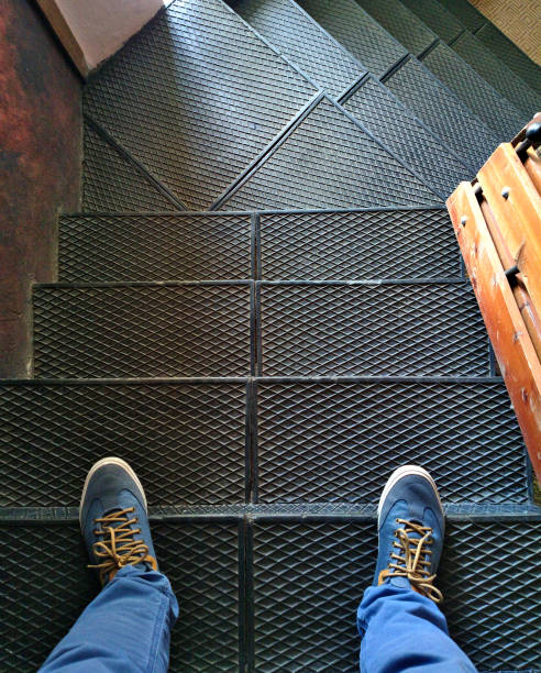 istock Feet are on the iron stairs. 1151954243