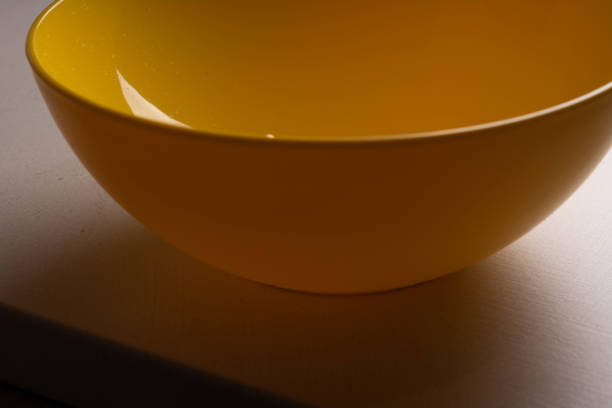 istock A yellow salad bowl with water drops on the wall is on the table. 1151954334