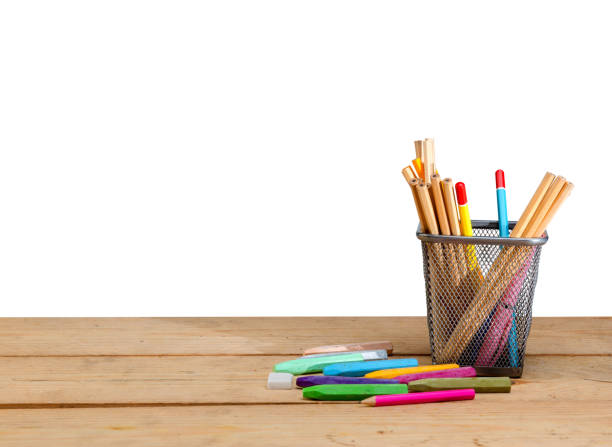 istock Pencils in basket container and colorful crayons on wooden table 1151954454