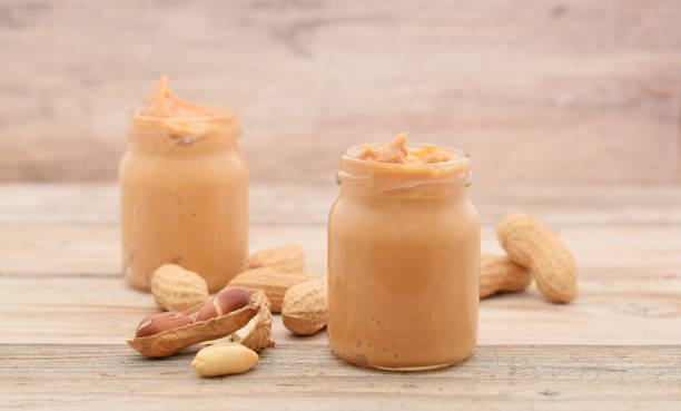 istock Peanut butter in glass with whole nuts 1151954989