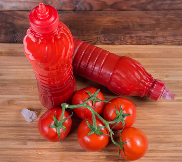 istock Top view of tomato sauce in plastic bottles, fresh tomatoes 1151955147