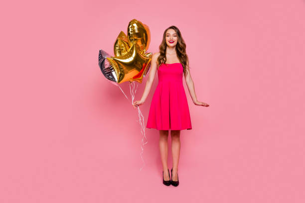 Full length body size photo beautiful amazing she her lady graduation day weekend hand arm hold star shape golden balloons gift present wear colorful formal-wear dress isolated pink bright background Full length body size photo beautiful amazing she her lady graduation day weekend hand arm hold star shape golden balloons gift present wear colorful formal-wear dress isolated pink bright background. 'formal dress' stock pictures, royalty-free photos & images