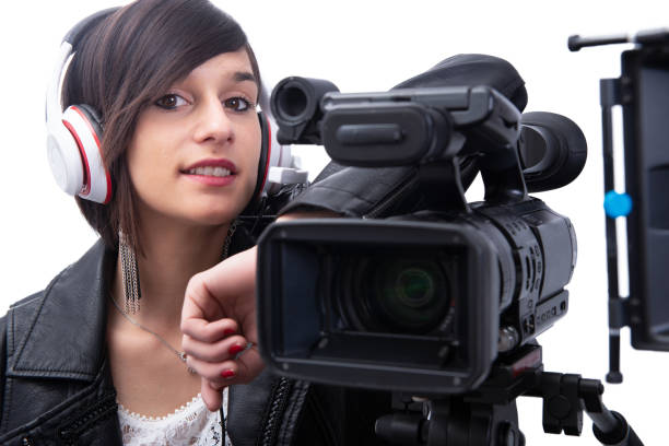istock young woman with professional video camera, isolated on white background 1151960636