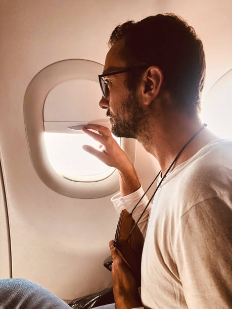 istock Passenger in a modern airplane seat next to the window. 1151962201