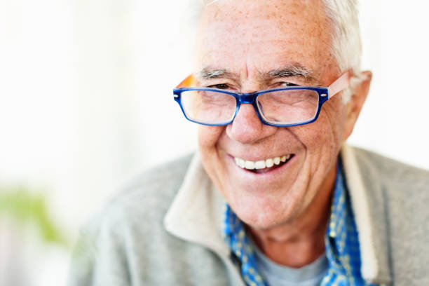 istock Laughing senior man in eyeglasses looks contented 1151963952