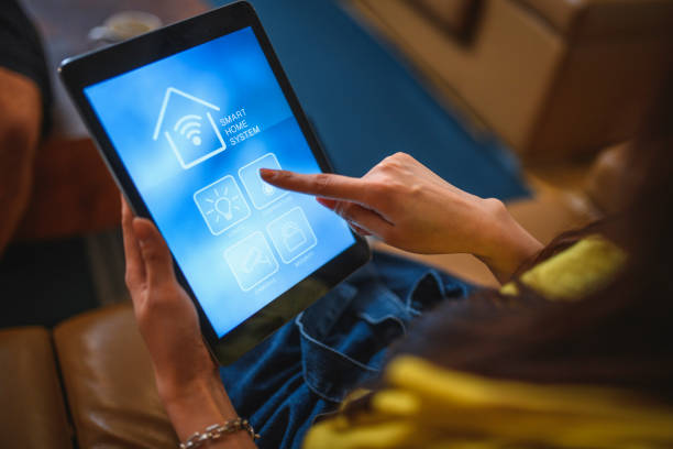 istock Taiwanese Woman Using Smart Home System App on Digital Tablet 1151963966