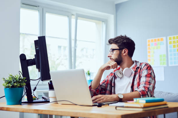 istock Focused young man thinking about his start-up business while looking at screen in home office 1151965039