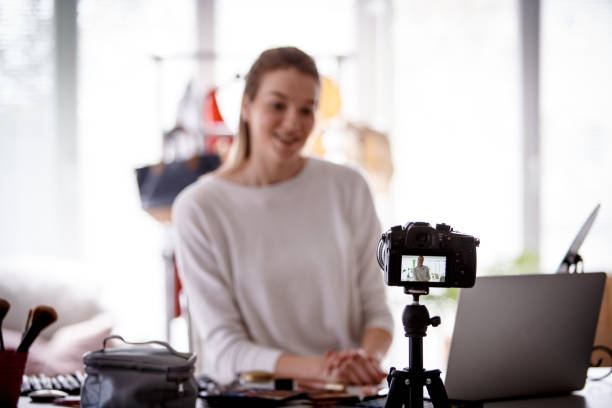 Selective focus at camera, makeup blogger recording video