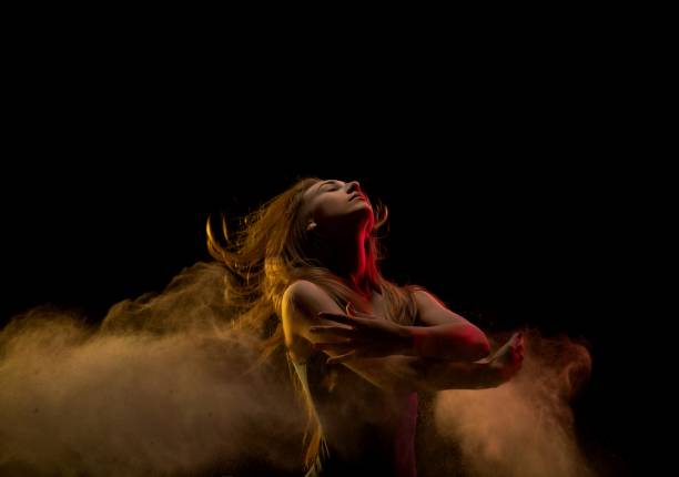 istock Blonde in dust cloud embracing herself view 1151966473