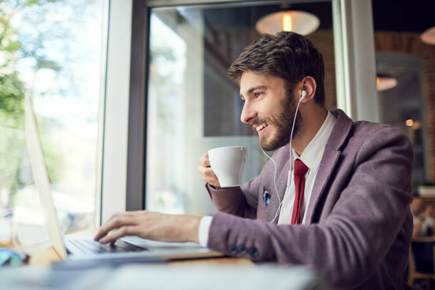 istock Young entrepreneur working on startup business while drinking coffee at a cafe and listening to music 1151966817
