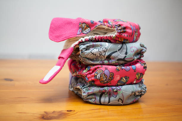 istock Stack of cloth diapers on a wooden table 1151967311