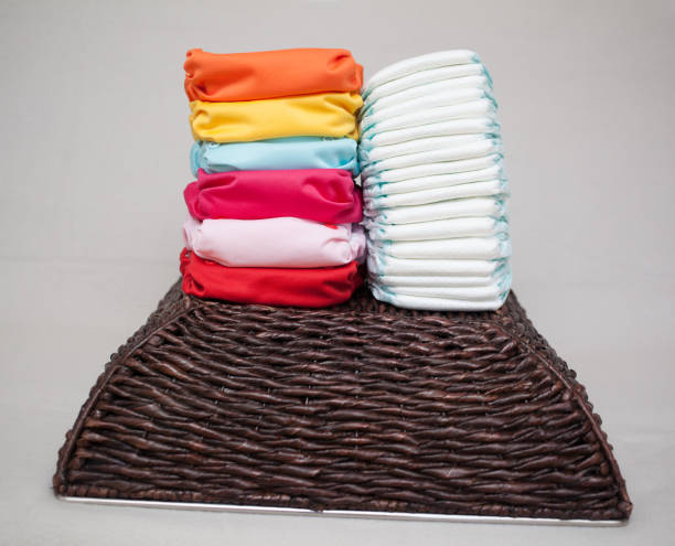 istock Stacks of disposable diapers and modern cloth diapers 1151968640