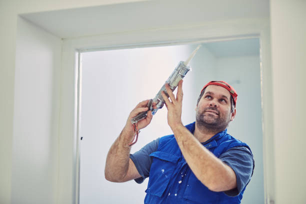istock Worker using silicone for walls and door frame inside the house - renovation fixes. 1151969041