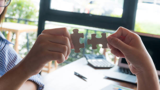 istock team building show hand try to put the missing jigsaw during hand 1151970226