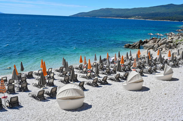 istock empty stone beach with sunshades in Rabac Croatia 1151970938