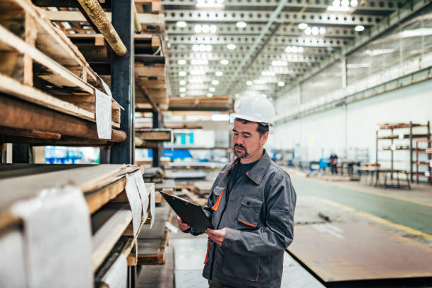 istock Mature supervisor with checklist at heavy industry factory warehouse. 1151972871