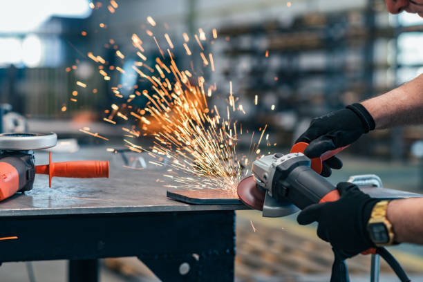 istock Hands of a worker cutting metal with hand grinder. 1151972982
