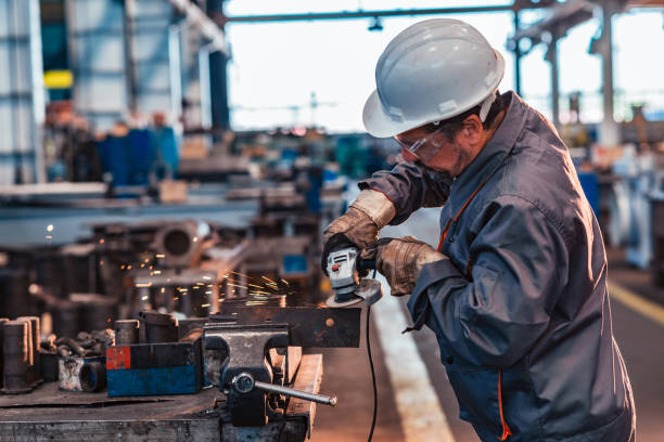 istock Skilled industrial worker grinding metal part. 1151973139