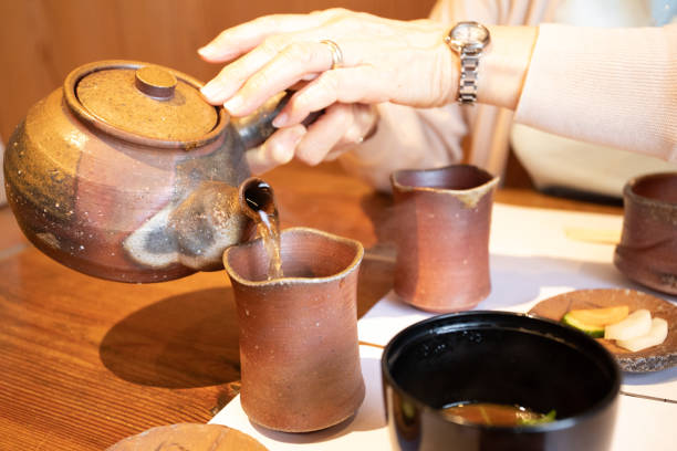 istock Woman pouring tea 1151974345