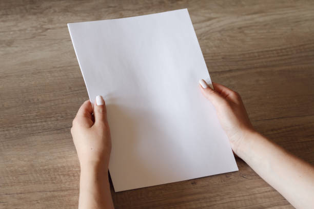 istock female hands with a sheet of paper 1151974520