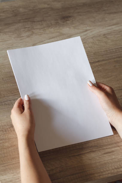 istock female hands with a sheet of paper 1151974597