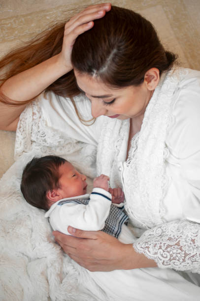 istock Young mother looking her newborn baby boy 1151974855