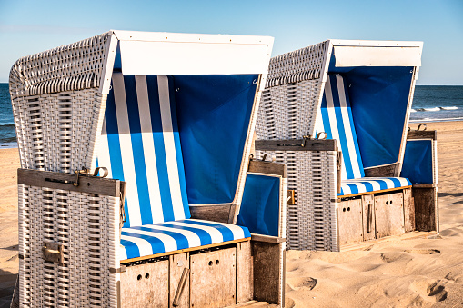 A wooden bench overlooks the waters of Cape Cod bay on a beach  in southeastern Massachusetts