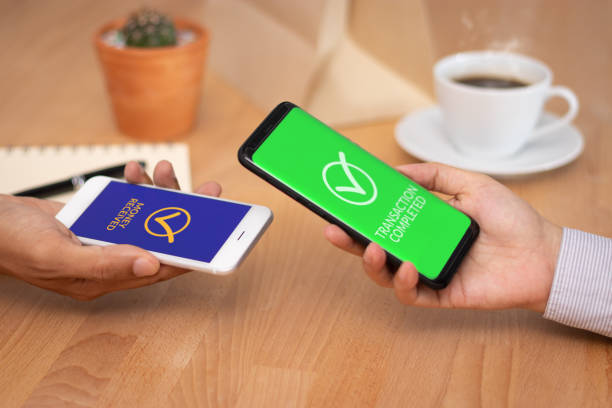 istock money transaction via mobile phone. business people using application wallet in mobile smartphone for transfer money to another bank account. 1151977126